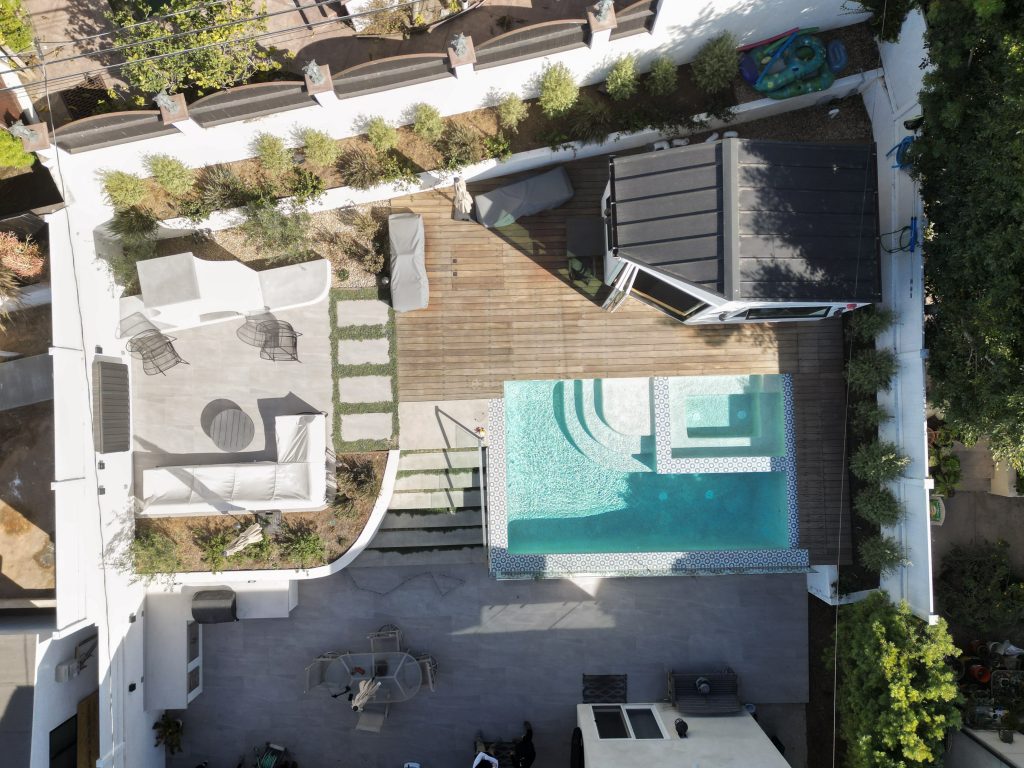 Outdoor backyard full renovation built by rosewood landscape inc in palos verdes. full build of pool, pool house, fire place, outdoor kitchen.